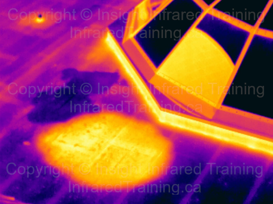Thermal image of surface and subsurface low slope / flat roof moisture.